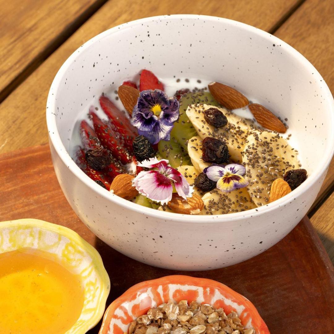 Adra Hostel Antigua Exterior photo A fruit salad with edible flowers